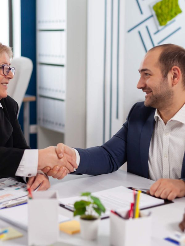 consultant-greeting-international-client-with-handshake-after-partnership.jpg