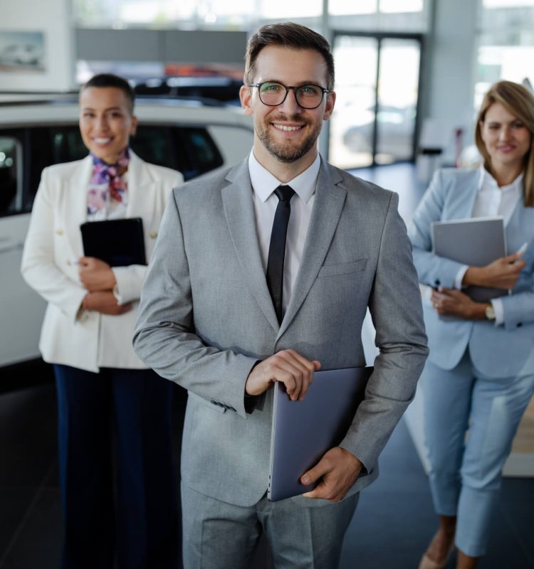 salesteam-in-dealership-three-beautiful-consultants-or-managers-in-elegant-suit-looking-on-camera-.jpg